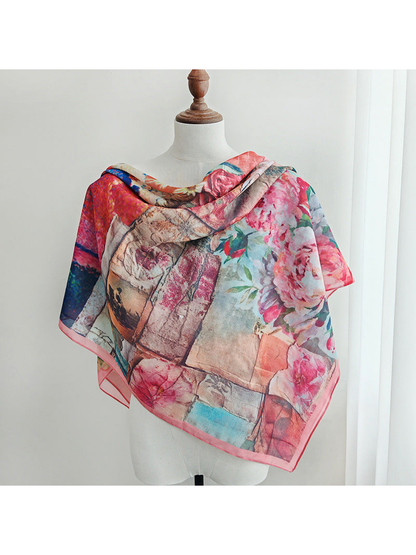 Multicolor floral scarf draped broadly across a mannequin's shoulders