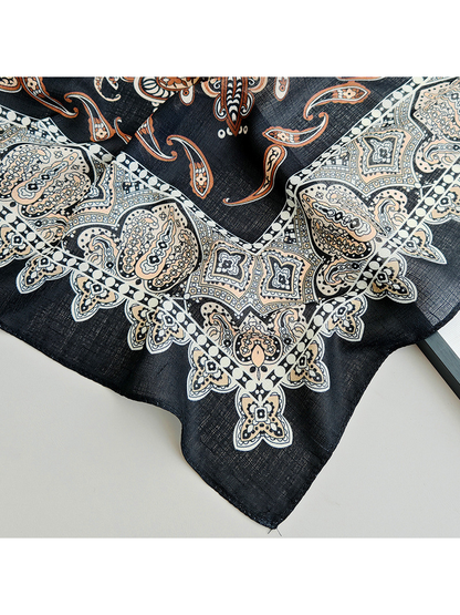 Close-up of the scarf's stitched corner and pale ornamental border