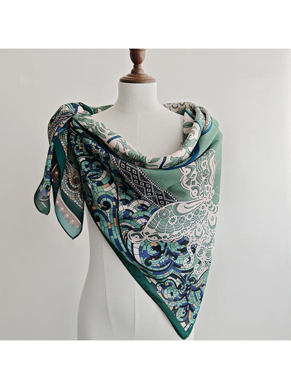 Green ornamental square scarf wrapped around a dress form