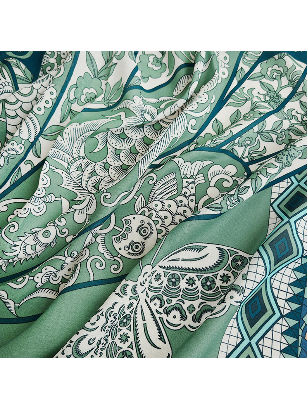 Close-up of green ornamental bird, floral, and geometric motifs