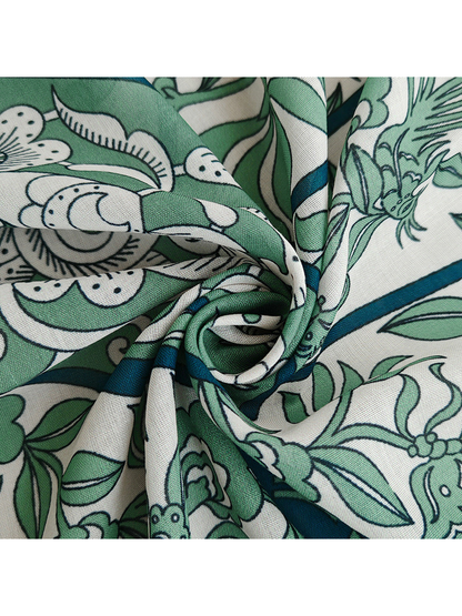 Close-up of the fine woven-look texture and green floral print