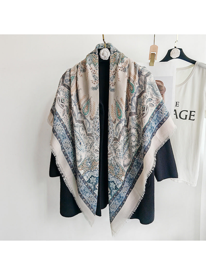 Light blue paisley scarf draped over a black coat