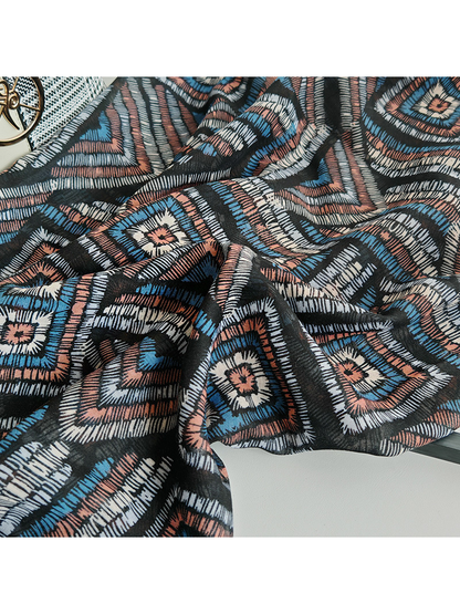Close-up of the multicolor geometric scarf pattern and draped surface