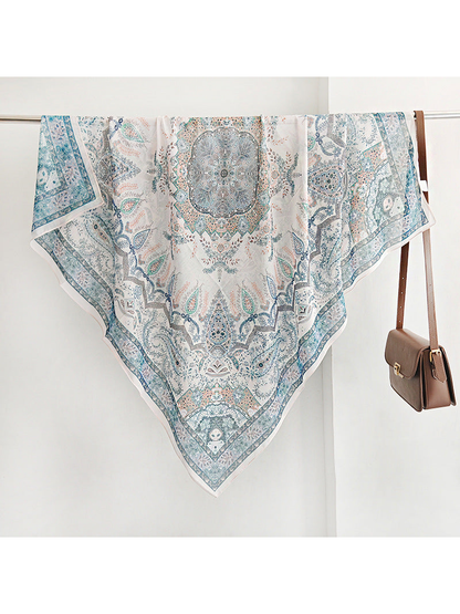 Blue square scarf with paisley motifs, central medallion and decorative border