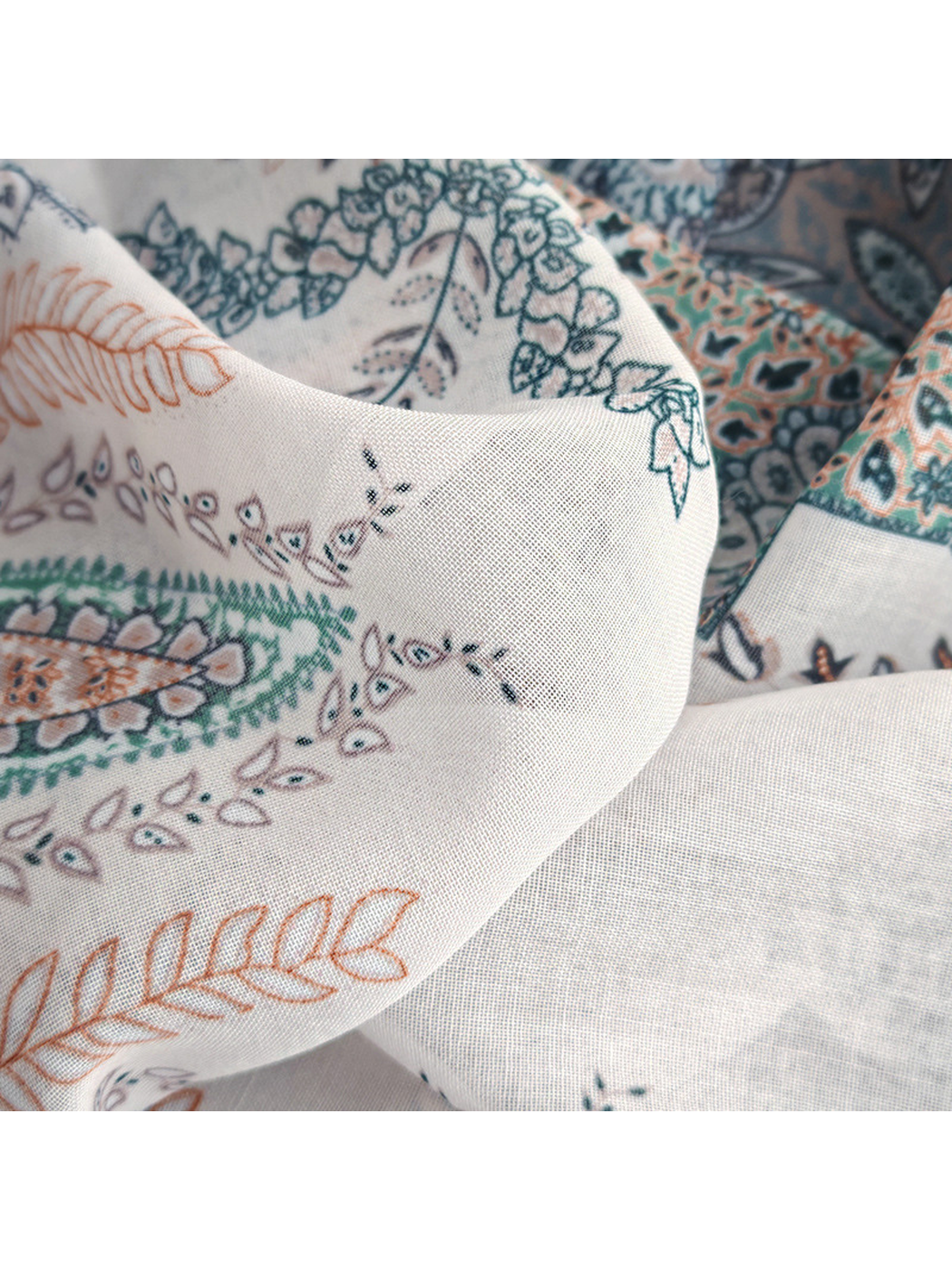 Close-up of the scarf's fine woven-look texture and printed motifs