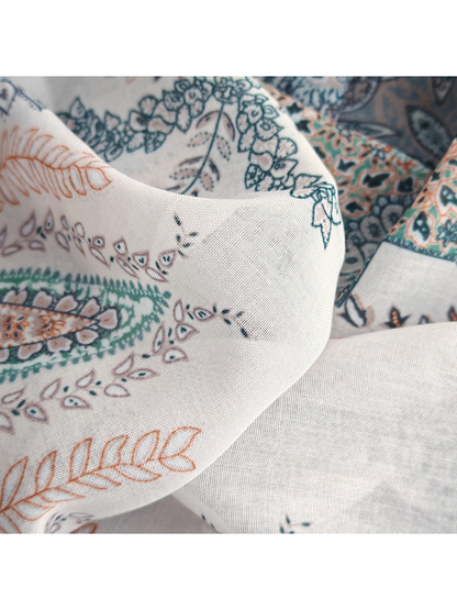 Close-up of the scarf's fine woven-look texture and printed motifs