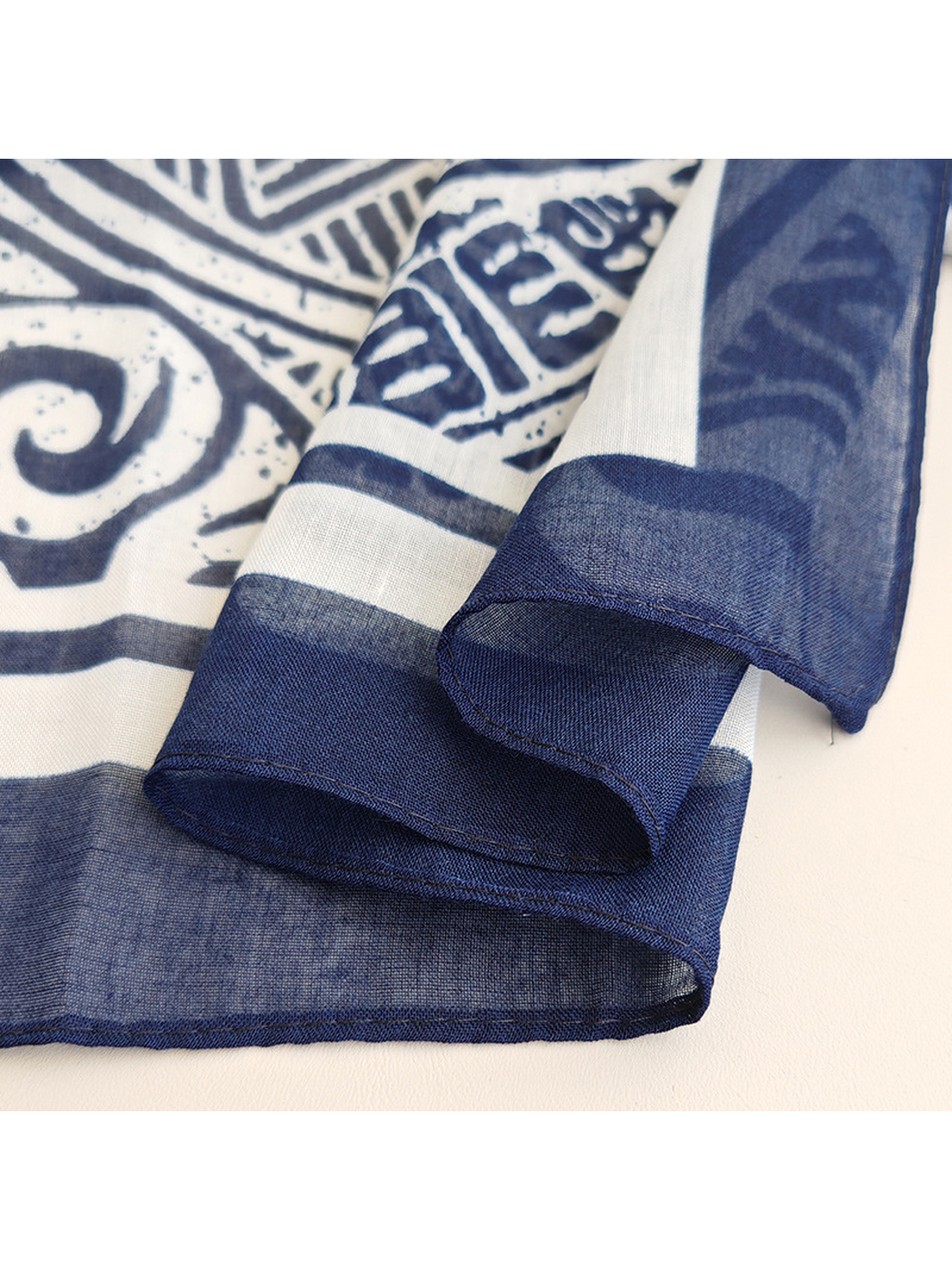 Close-up of the navy striped border and stitched scarf edge