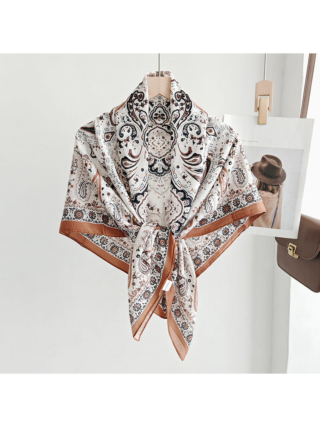 Ivory paisley square scarf tied around a hanger