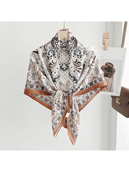 Ivory paisley square scarf tied around a hanger