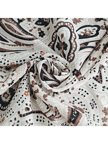 Close-up of the scarf's fine crosshatched texture and paisley print