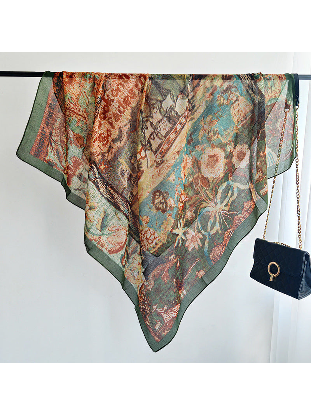 Multicolor square scarf draped over a clothing rail