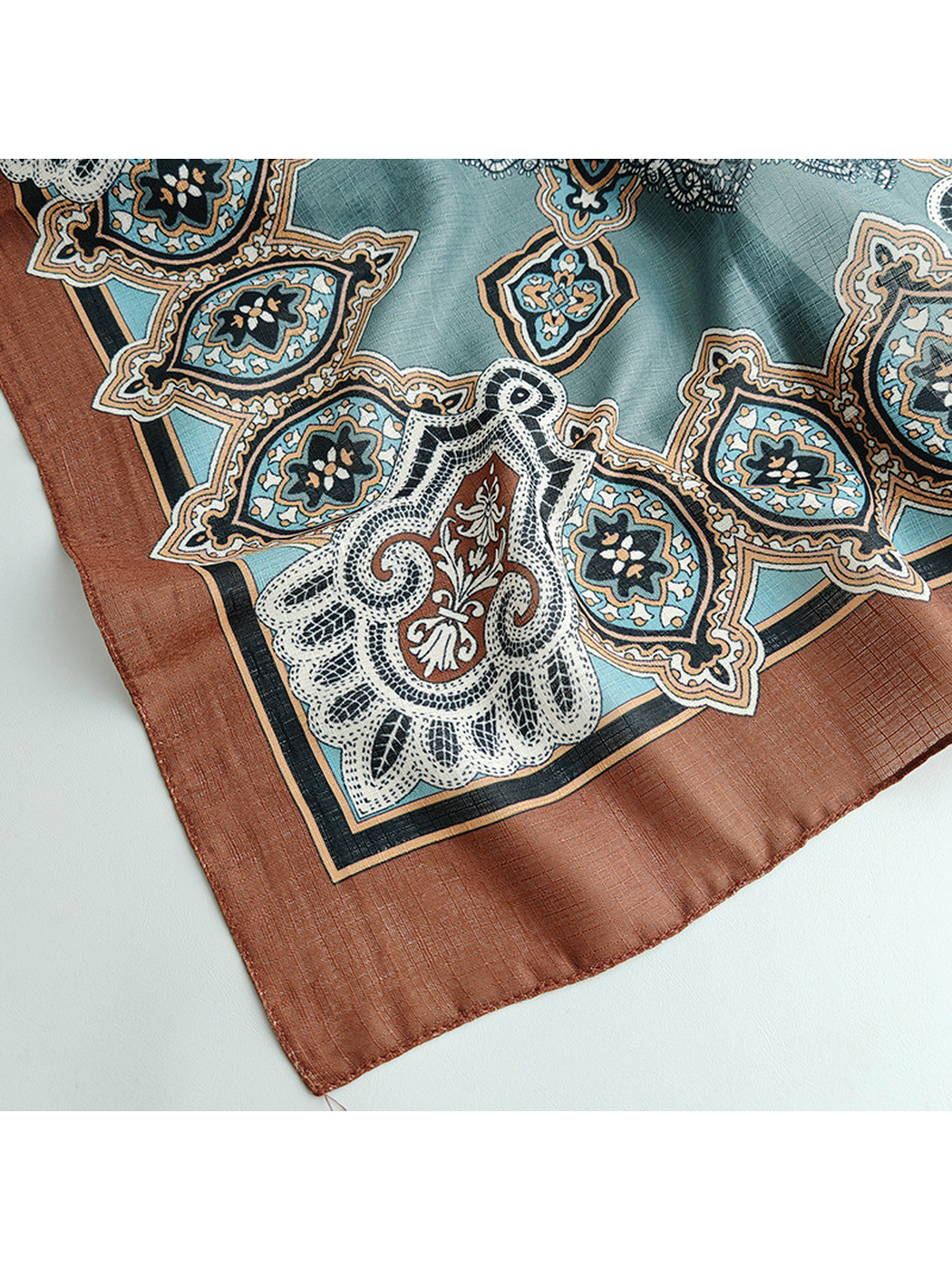 Close-up of the rust-brown border and narrow stitched edge