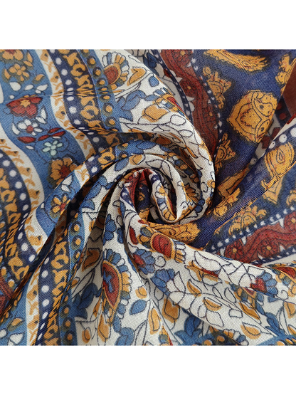 Close-up of the scarf's fine woven-look texture and multicolor ornamental print