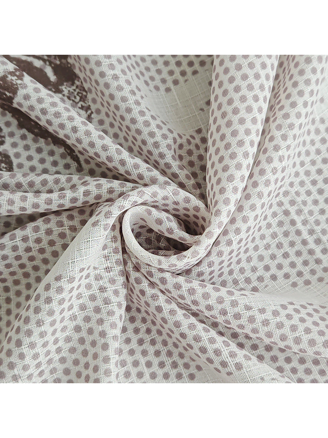 Close-up of the pale dotted scarf gathered to show its woven-look texture