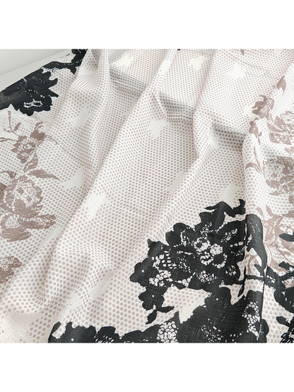 Close-up of the scarf's semi-sheer dotted texture and floral print
