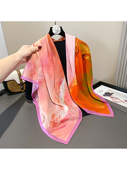 Pink and orange abstract square scarf draped over a display form