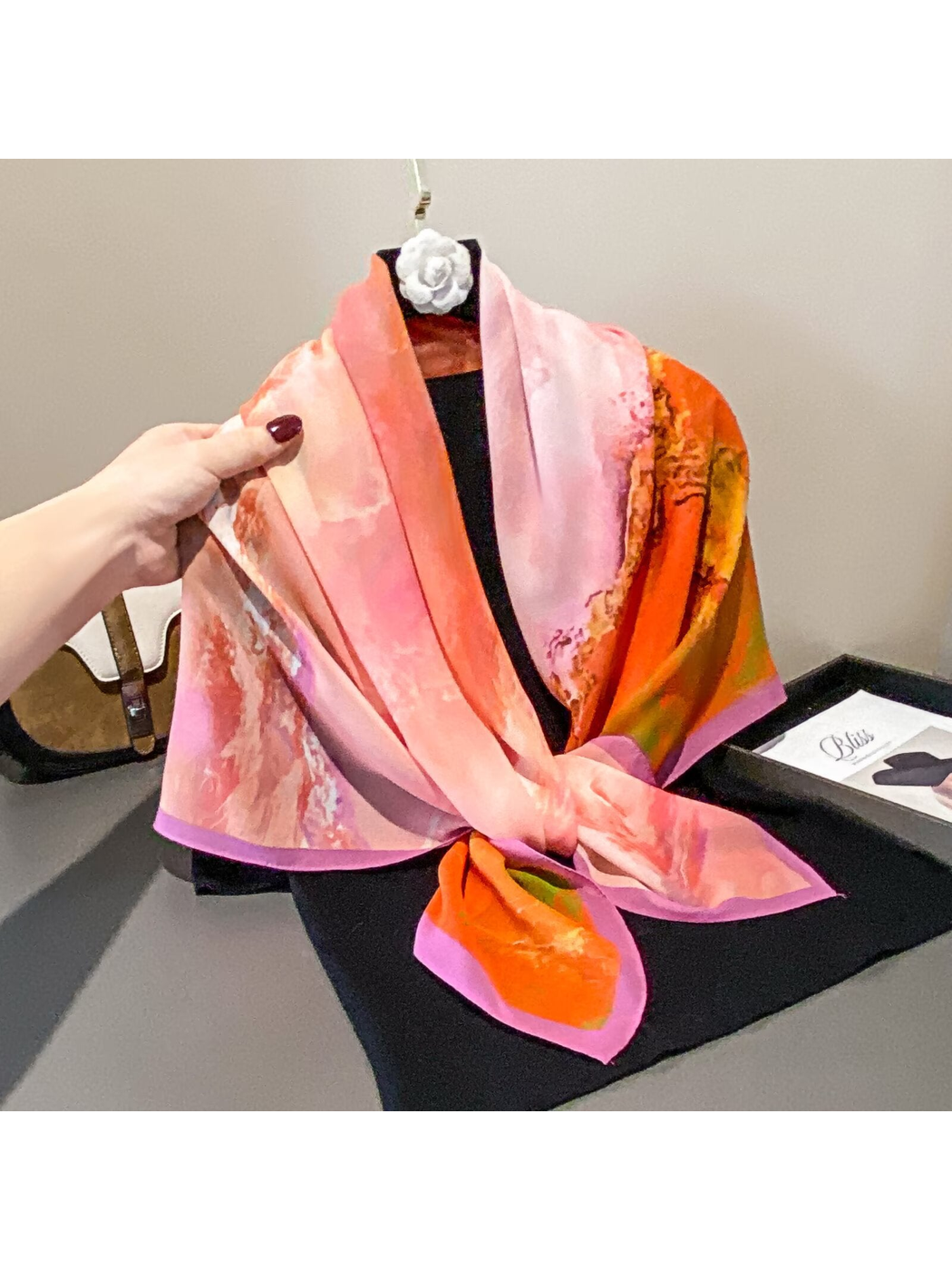 Pink and orange abstract square scarf styled with a front knot