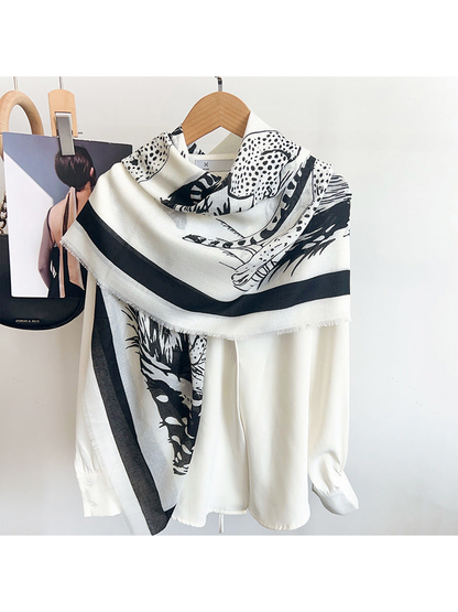 Ivory big-cat print scarf styled over a white blouse
