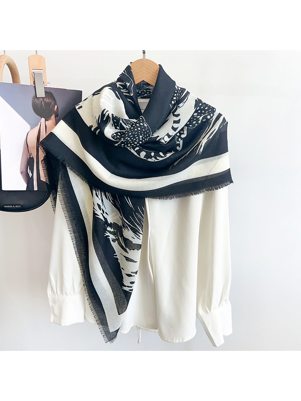 Black and ivory big-cat print scarf styled over a white blouse