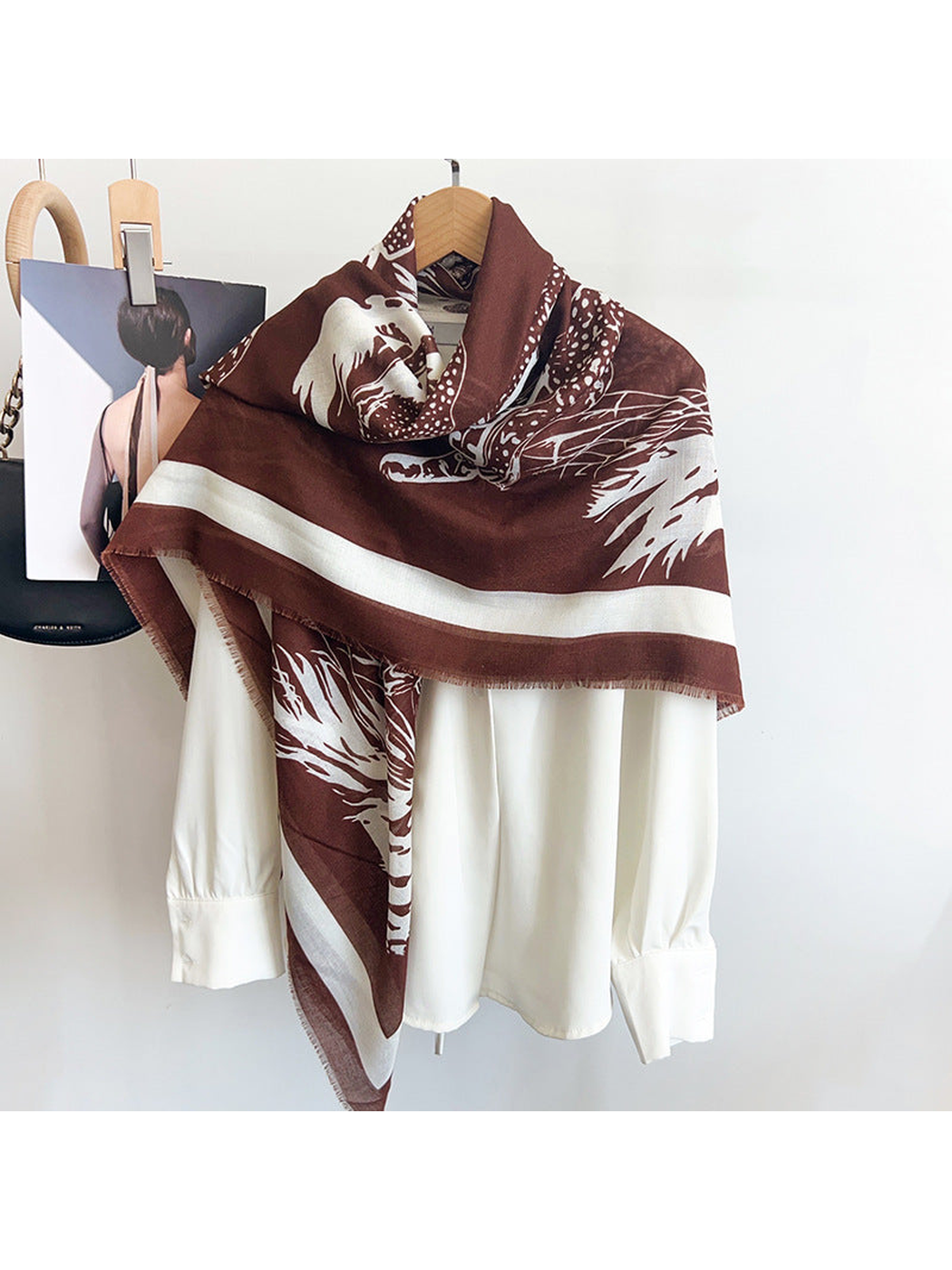 Brown and ivory big-cat print scarf styled over a white blouse
