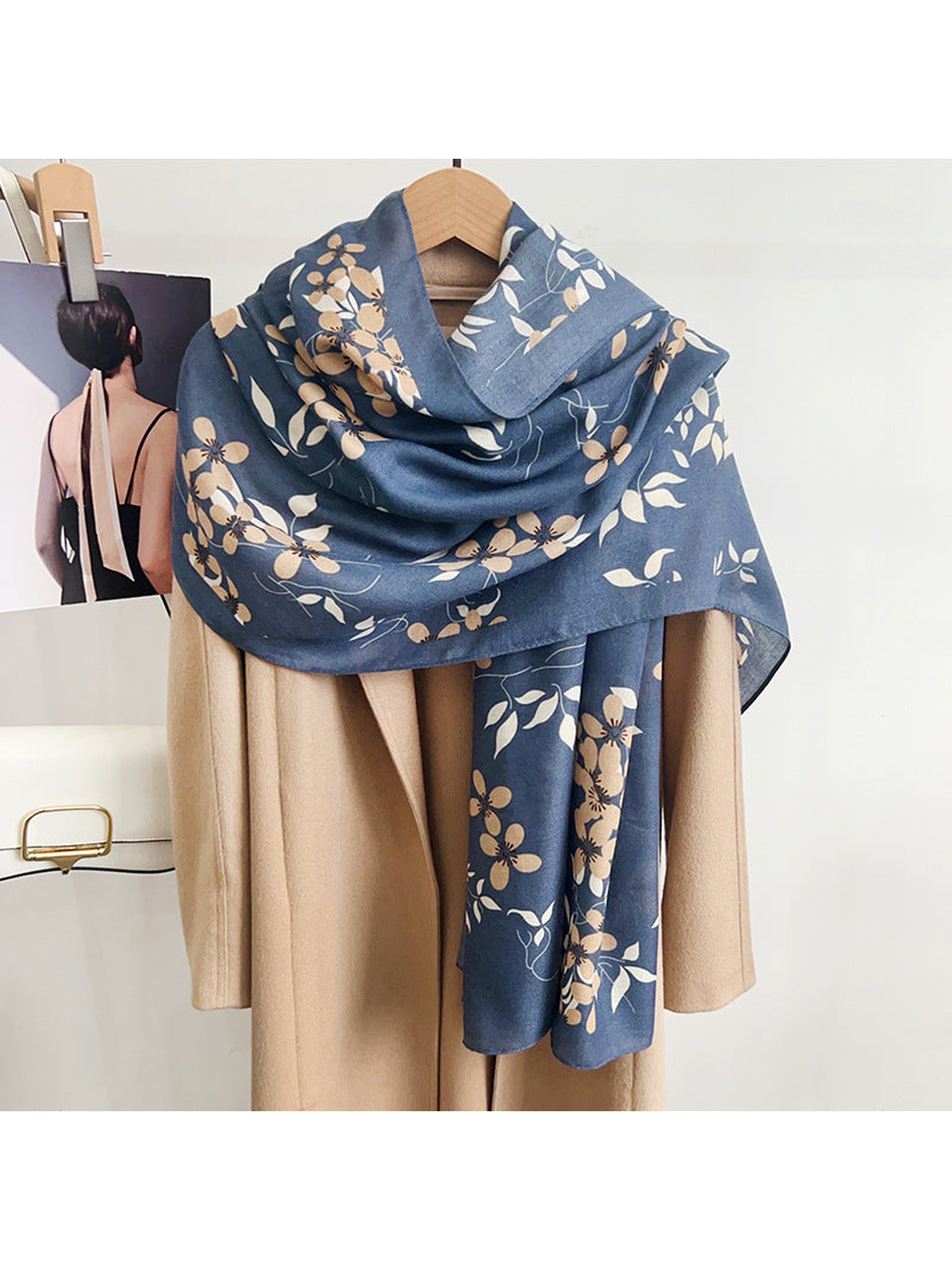 Blue-gray floral scarf draped over a beige coat