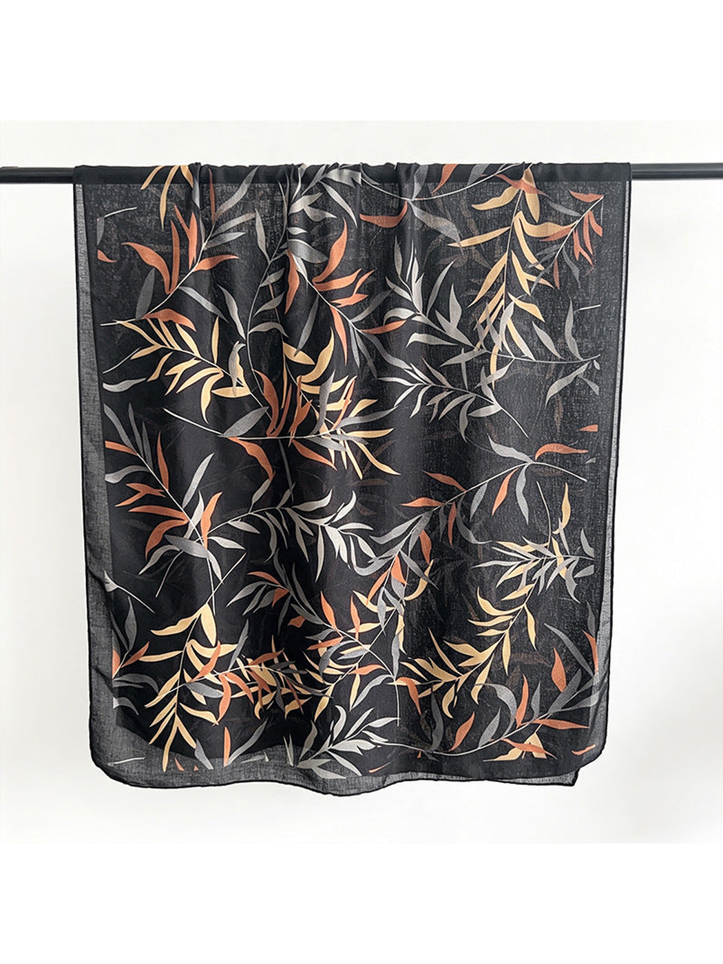 Black rectangular scarf with gray, tan and rust leafy branches