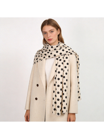 Ivory polka-dot scarf styled over a light coat