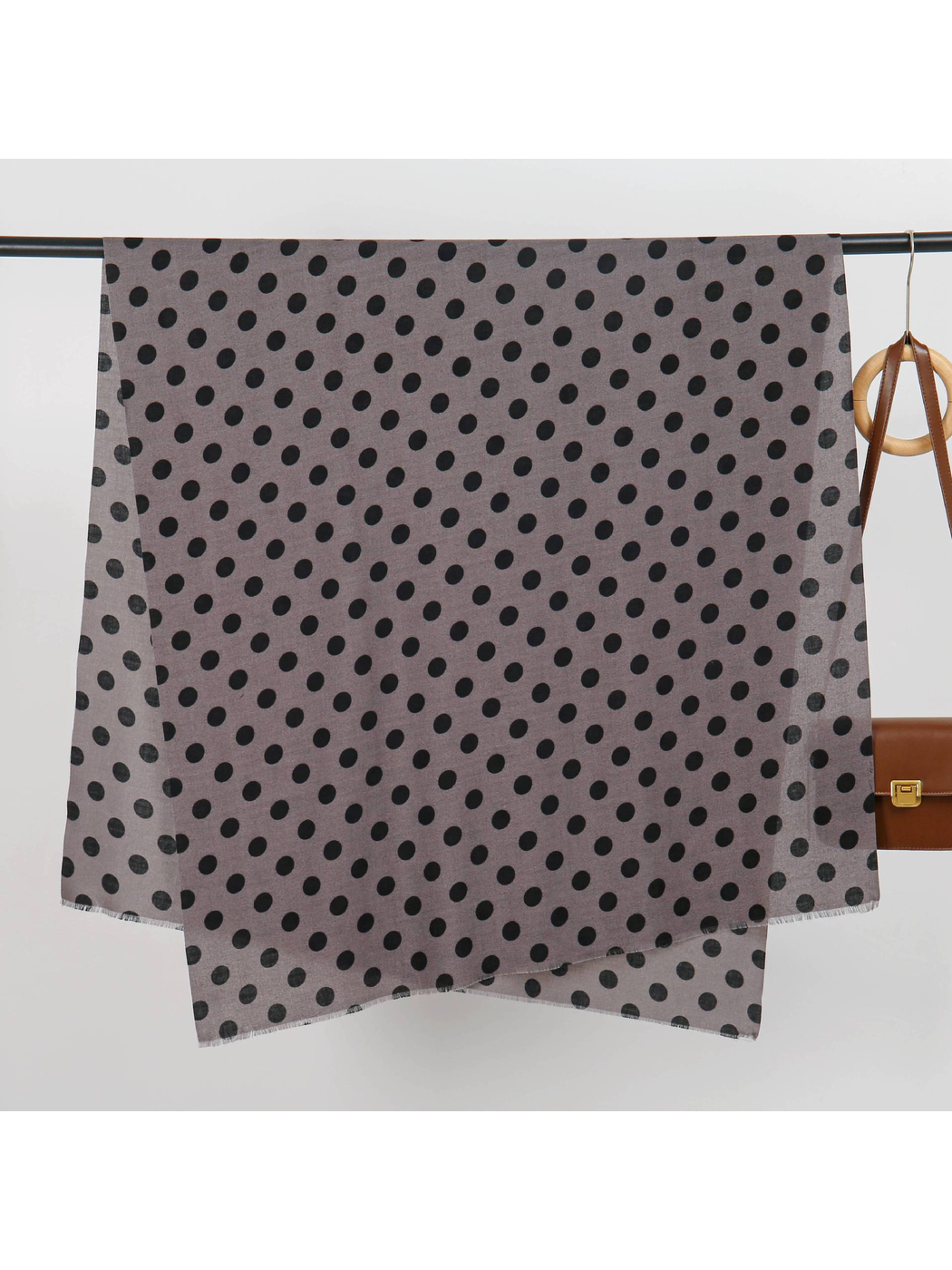 Gray polka-dot scarf spread open to show its rectangular shape and fringed edges