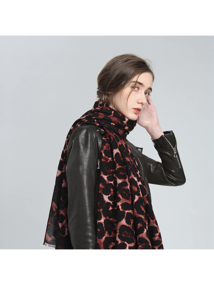 Burgundy abstract leopard-print scarf wrapped around the neck