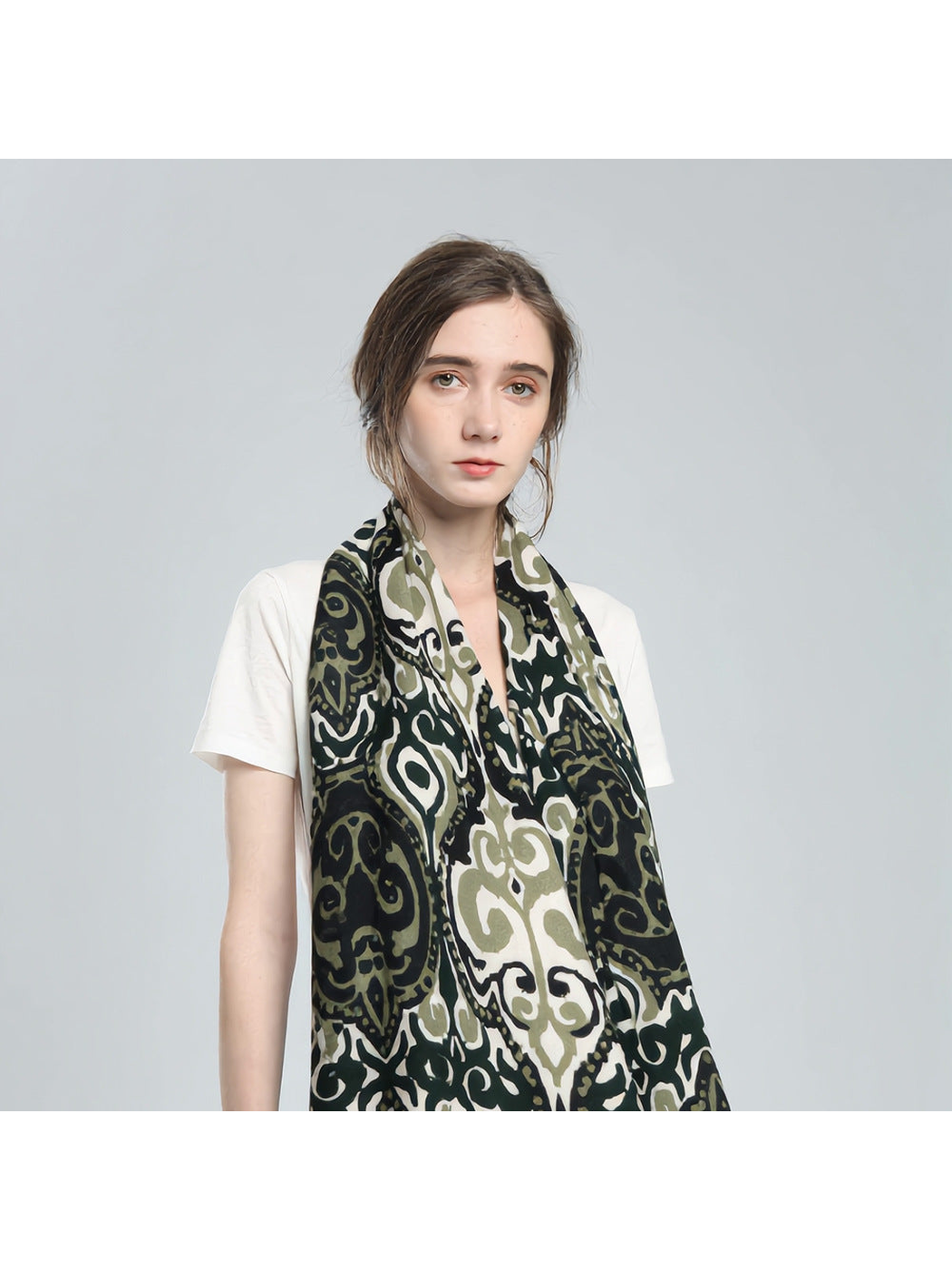 Green ornamental scarf worn in a long front drape