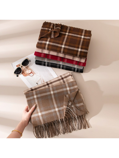 Taupe plaid fringe scarf held beside a stack of assorted colors