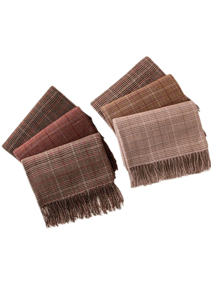 Six plaid fringed scarves arranged together on a white background