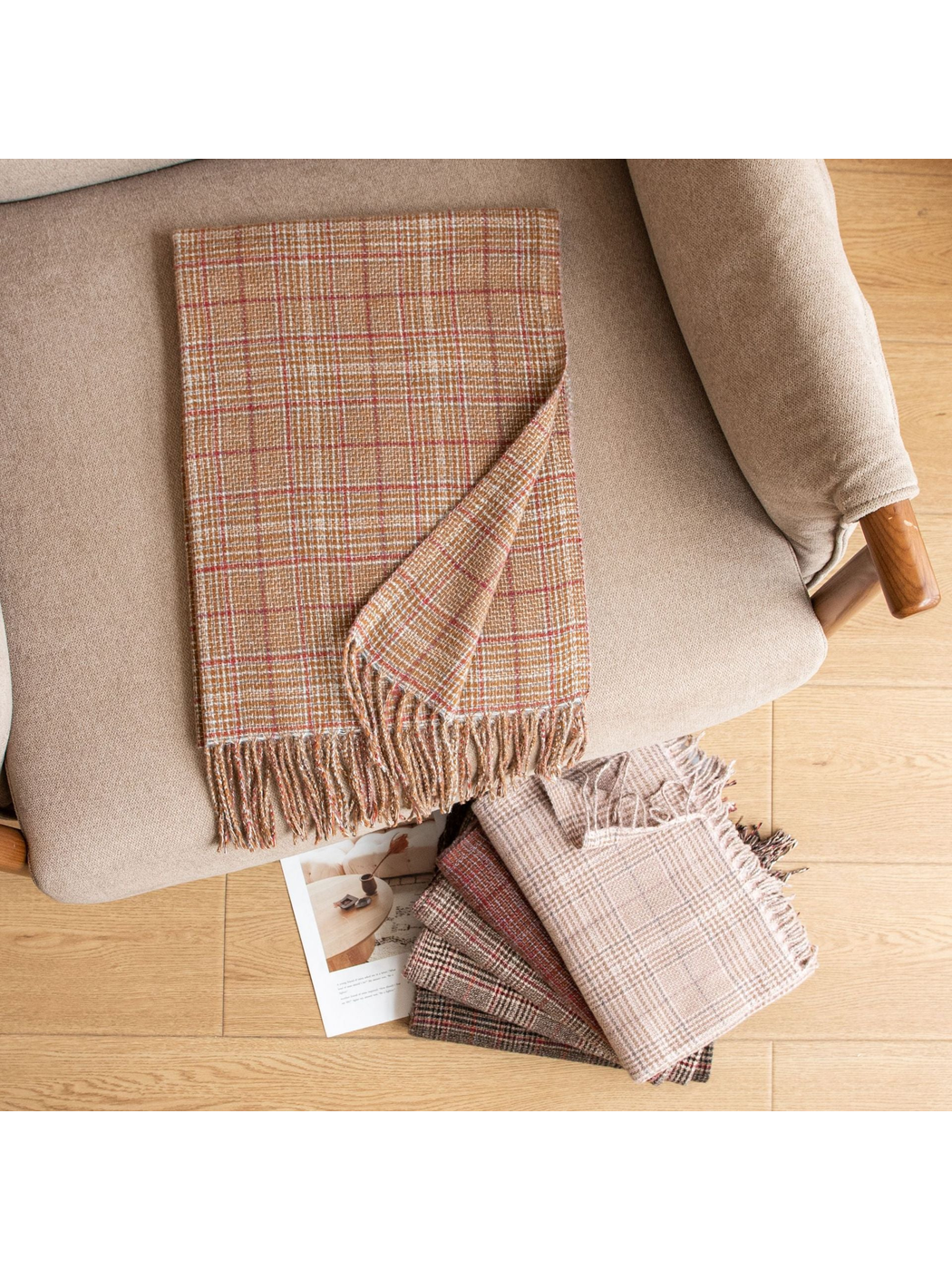 Camel plaid scarf displayed with coordinating colors on an armchair