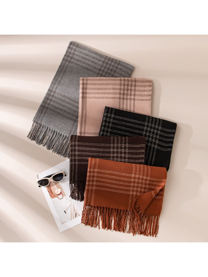 Assorted plaid scarves arranged flat with fringed edges visible