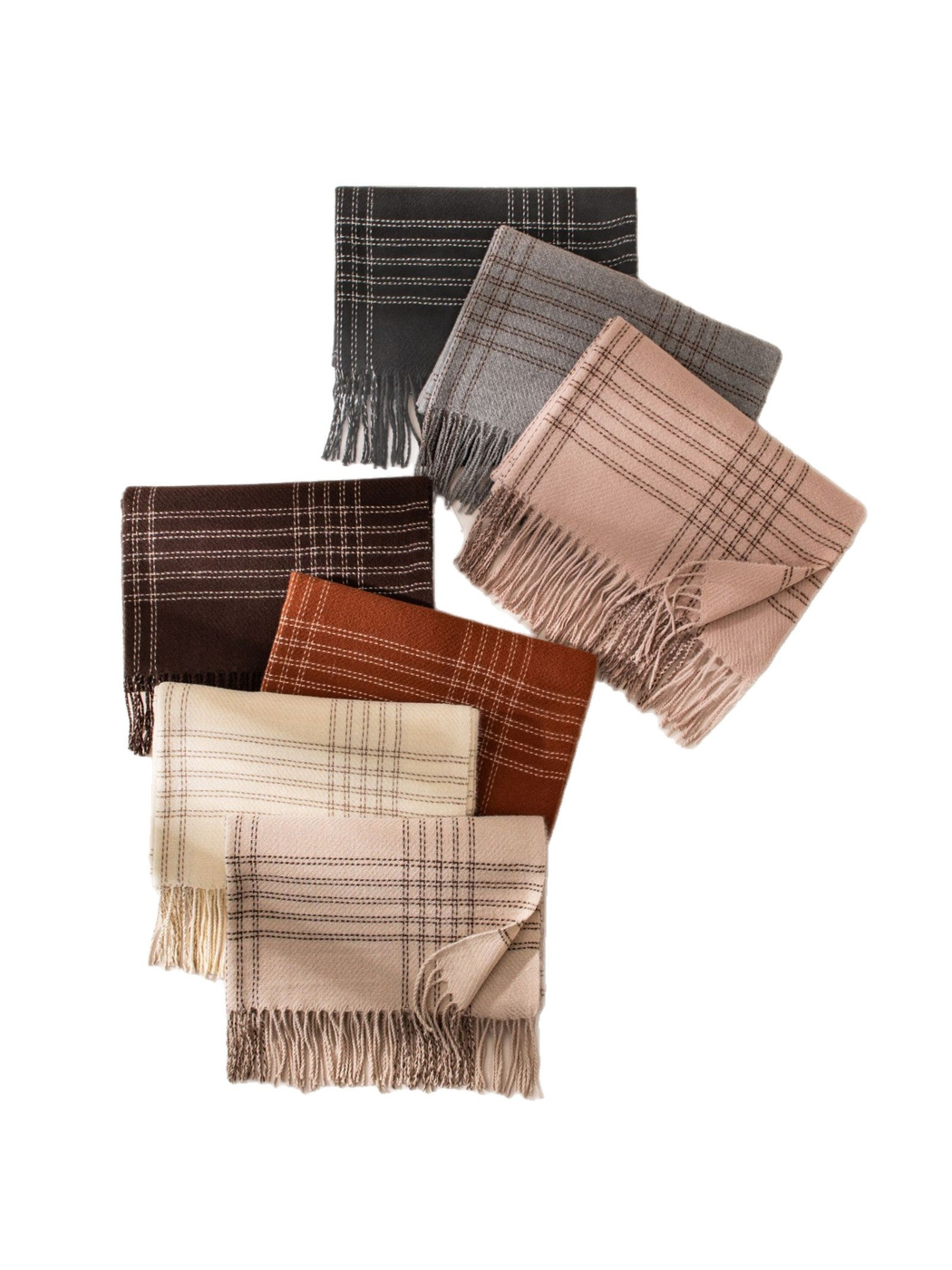 Seven windowpane plaid scarves arranged together on a white background
