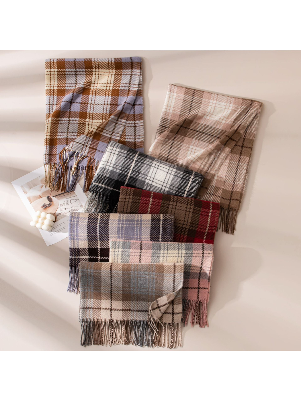 Assorted plaid scarves arranged together in multiple colors