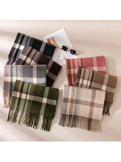 Seven plaid fringe scarf colorways arranged together in a flat lay