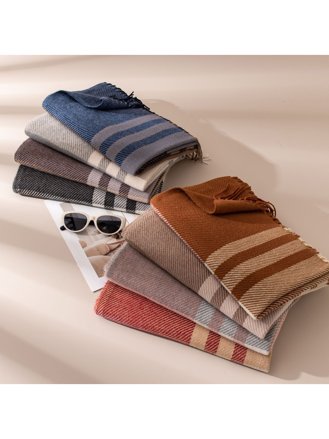 Assorted plaid scarves folded in two stacked displays