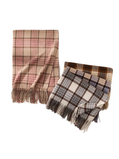 Pink and gray plaid fringed scarves displayed with additional folded colors