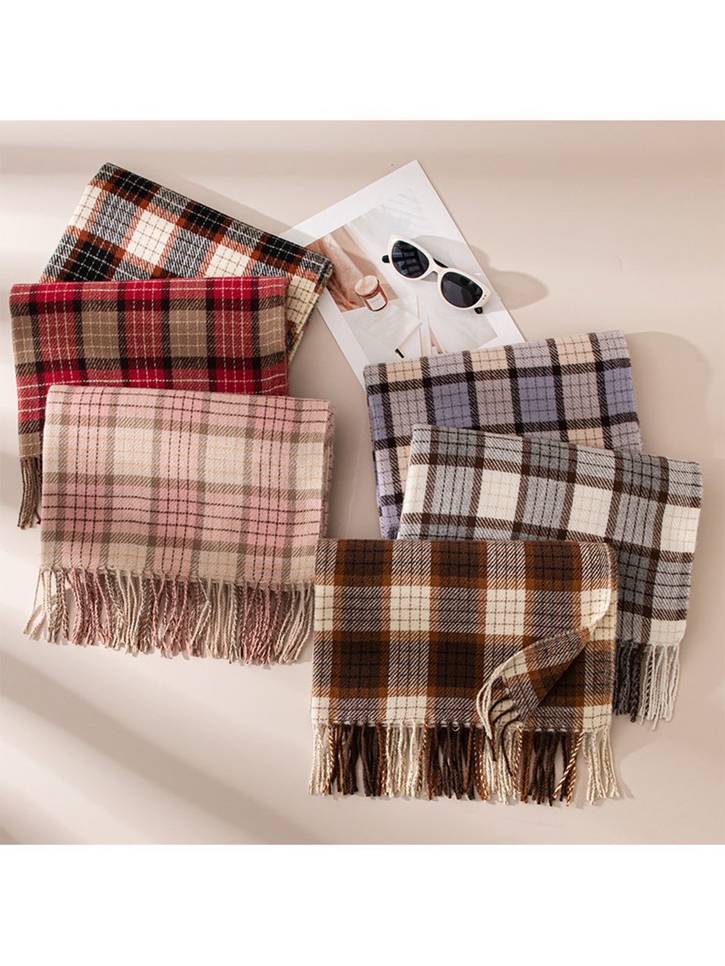 Six plaid fringed scarves arranged in overlapping color groups