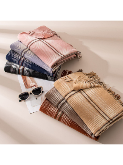 Seven plaid scarf colors arranged in two folded stacks with fringed edges visible