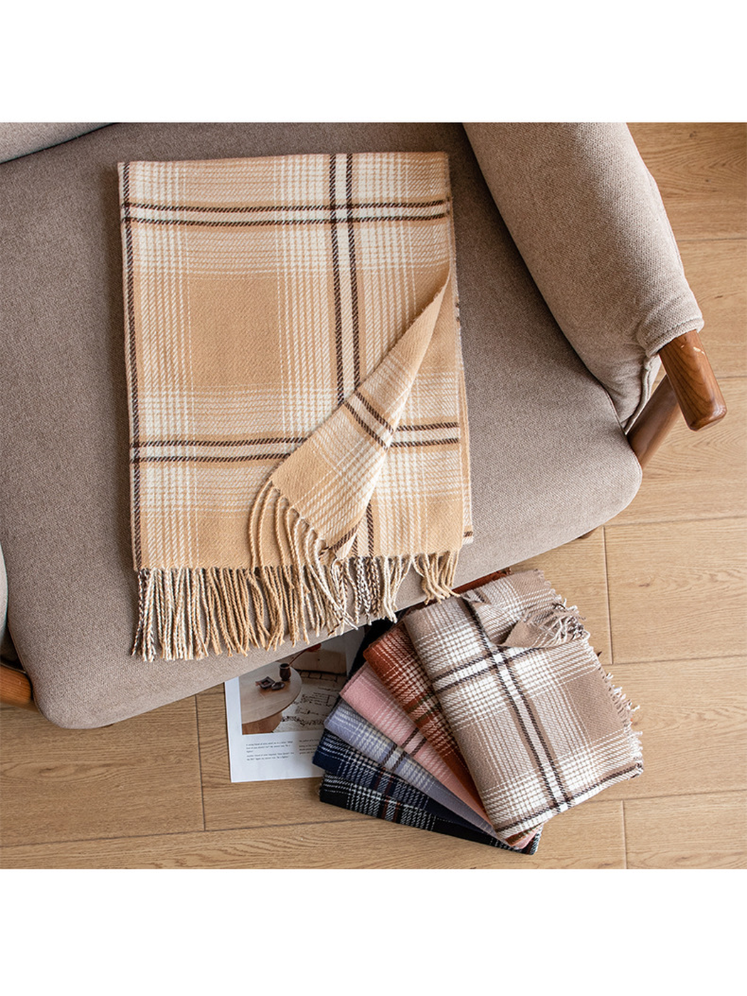 Camel plaid scarf arranged on a lounge chair beside folded color options