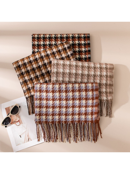 Four houndstooth scarves arranged together with fringed edges