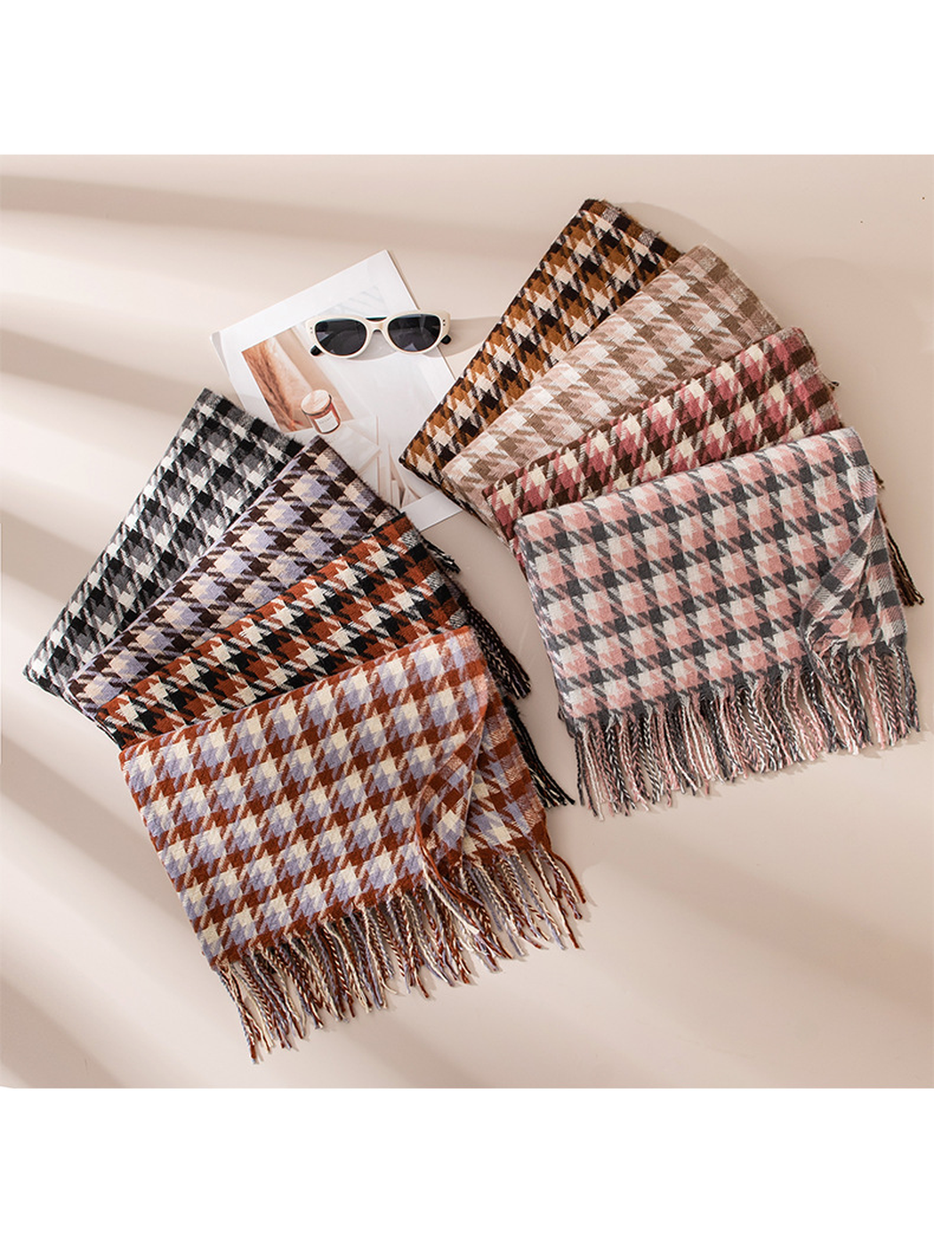 Eight houndstooth scarves fanned out with fringed ends visible