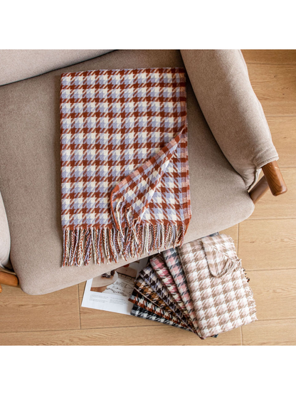 Blue and rust houndstooth scarf displayed across an upholstered chair