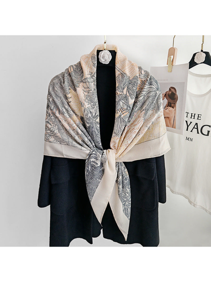 Cream botanical square scarf tied at the front over a black coat