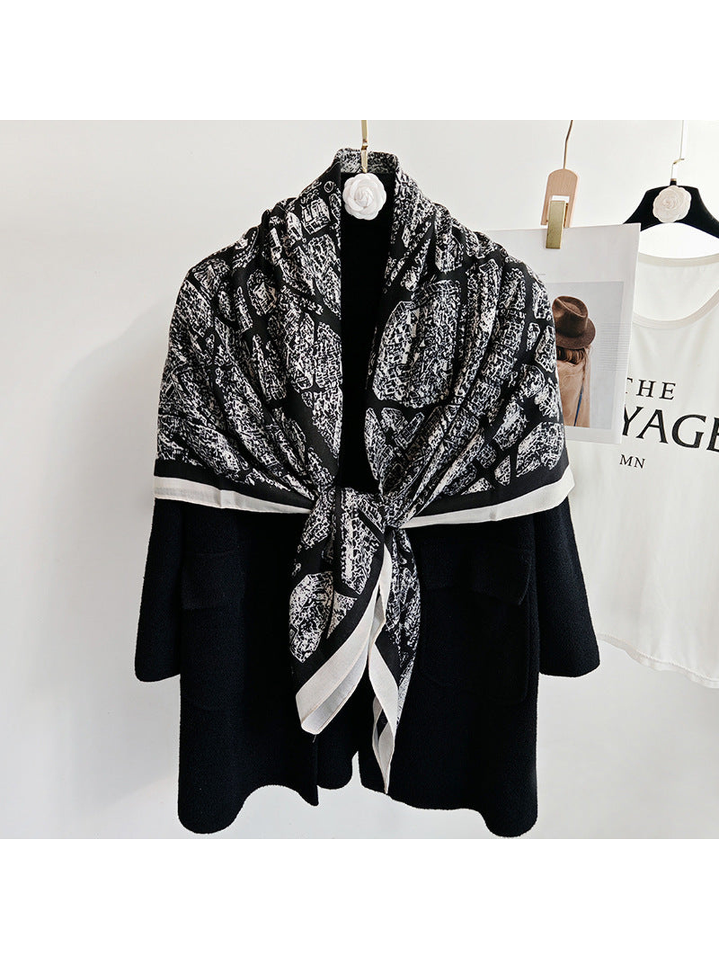 Black-base city-map scarf tied at the front over a black coat