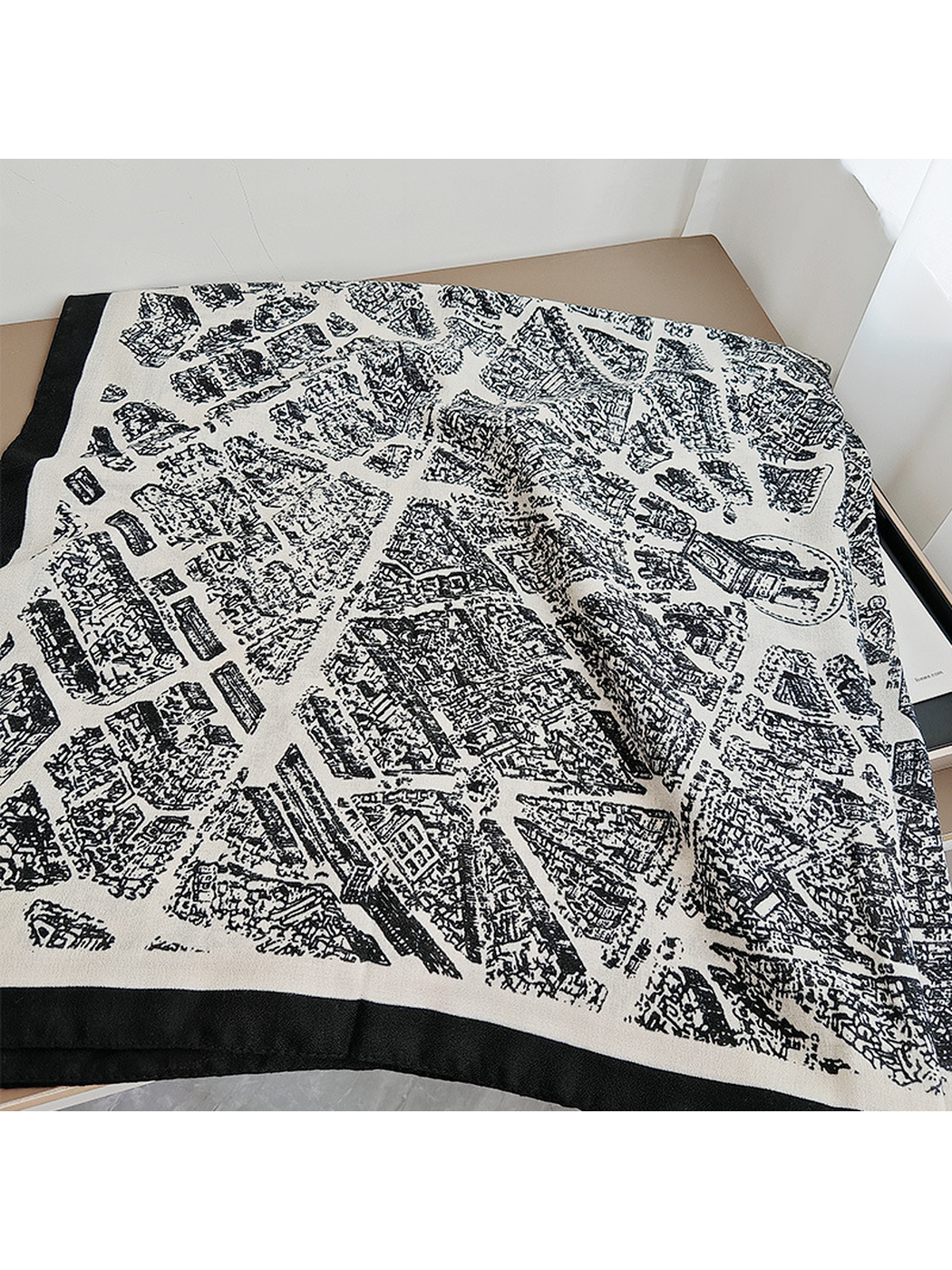 Close-up of the black city-map print across the white-base scarf