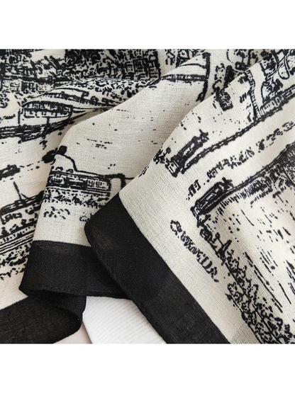 Close-up of the white-base scarf's fine woven-look texture and black border