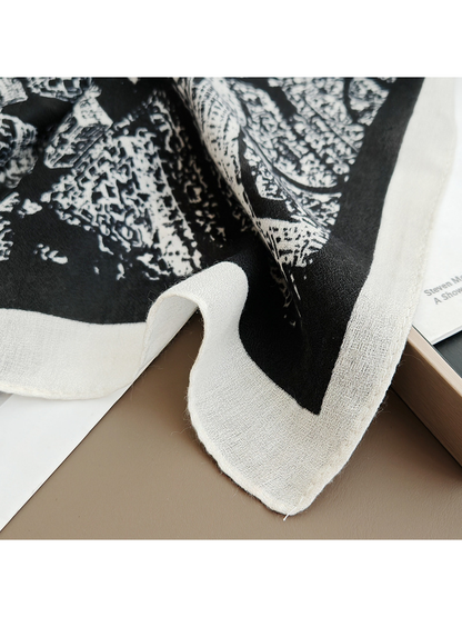 Close-up of the black-base scarf's white border and fine woven-look texture